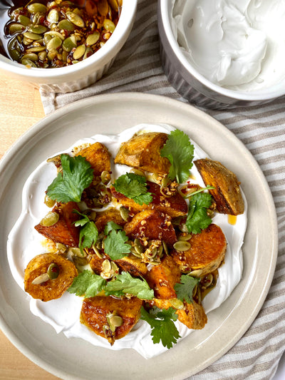 Curried Sweet Potatoes with Coconut Yogurt and Pepita Chili Oil